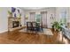 Dining room with fireplace, hardwood floors, and view of the backyard at 10 Nesbit Reserve Ct, Atlanta, GA 30350