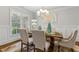 Charming dining room with a wooden table, upholstered chairs, and natural light at 10 Nesbit Reserve Ct, Atlanta, GA 30350