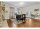 Bright dining room featuring hardwood floors, area rug, fireplace, and natural light at 10 Nesbit Reserve Ct, Atlanta, GA 30350