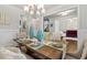 Bright dining room with chandelier, decorative vases, and natural lighting at 10 Nesbit Reserve Ct, Atlanta, GA 30350