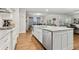 Kitchen island with stainless dishwasher, granite countertops, and hardwood floors at 10 Nesbit Reserve Ct, Atlanta, GA 30350