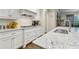 Kitchen features white cabinets, stainless appliances, granite counters, and a subway tile backsplash at 10 Nesbit Reserve Ct, Atlanta, GA 30350