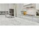 Kitchen features white cabinets, stainless appliances, granite counters, and a subway tile backsplash at 10 Nesbit Reserve Ct, Atlanta, GA 30350