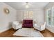 Cozy living room featuring elegant furniture, a decorative mirror, and hardwood floors at 10 Nesbit Reserve Ct, Atlanta, GA 30350