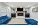 Spacious living room features a fireplace, TV, blue sofas, and an area rug at 10 Nesbit Reserve Ct, Atlanta, GA 30350