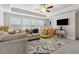 Large living room featuring neutral colors, a ceiling fan, a large sofa, and a playful atmosphere at 10 Nesbit Reserve Ct, Atlanta, GA 30350