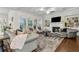 Cozy living room with a fireplace, built-in shelving, and large windows at 10 Nesbit Reserve Ct, Atlanta, GA 30350