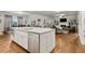 Open living room with hardwood floors, coffered ceiling, fireplace, and view of dining area and kitchen at 10 Nesbit Reserve Ct, Atlanta, GA 30350