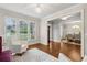 Bright living room with hardwood floors and an open view to dining room at 10 Nesbit Reserve Ct, Atlanta, GA 30350