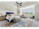 Spacious main bedroom with bright windows, a sitting area, and a navy blue bed frame at 10 Nesbit Reserve Ct, Atlanta, GA 30350