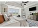 Bright bedroom with an upholstered bench, a large dresser, and many windows for natural light at 10 Nesbit Reserve Ct, Atlanta, GA 30350