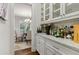 Butler's pantry and dining room with granite countertops and storage cabinets at 10 Nesbit Reserve Ct, Atlanta, GA 30350