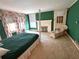 Bedroom with dark green walls featuring a fireplace, windows, and decorative touches at 1242 Star Ne Dr, Brookhaven, GA 30319