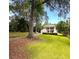 Landscaped lawn showing a charming two-story home with a detached garage and a long driveway at 1242 Star Ne Dr, Brookhaven, GA 30319