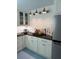 Charming kitchen with white cabinets, dark countertops, and modern lighting at 1242 Star Ne Dr, Brookhaven, GA 30319
