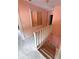 Traditional staircase with light carpet and white railing leads to the upper level at 1242 Star Ne Dr, Brookhaven, GA 30319