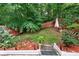 The backyard is beautifully landscaped with stone stairs, plants and a privacy fence at 248 Springbottom Dr, Lawrenceville, GA 30046