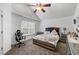 This bedroom features a tray ceiling, carpeted floors, and a large window at 248 Springbottom Dr, Lawrenceville, GA 30046