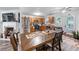 Open concept featuring kitchen with wood cabinets and stainless appliances, with an adjacent dining area and fireplace at 248 Springbottom Dr, Lawrenceville, GA 30046
