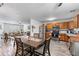 Modern kitchen with wood cabinetry and stainless steel appliances adjoining a dining area with seating for four at 248 Springbottom Dr, Lawrenceville, GA 30046