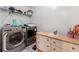 Well-lit laundry room equipped with side-by-side washer and dryer at 248 Springbottom Dr, Lawrenceville, GA 30046
