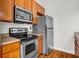 Close up view of kitchen featuring stainless steel appliances and wood cabinets with dark countertop at 502 Sw Pryor Sw St # 325, Atlanta, GA 30312