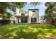 Spacious backyard featuring lush lawn, modern home exterior, covered patio, and privacy fence at 555 Orme Ne Cir, Atlanta, GA 30306