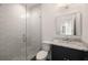 Bathroom with white-tiled shower, sleek vanity with marble countertop at 555 Orme Ne Cir, Atlanta, GA 30306