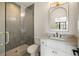 Bathroom featuring a gray tiled shower with glass door, and marble countertop vanity at 555 Orme Ne Cir, Atlanta, GA 30306