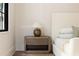 Close up of a wooden bedside table with lamp next to a white bed at 555 Orme Ne Cir, Atlanta, GA 30306