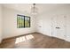 Bright bedroom with hardwood floors, a large window, and two closet doors at 555 Orme Ne Cir, Atlanta, GA 30306