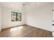 Bedroom features hardwood floors, black framed windows, and neutral paint at 555 Orme Ne Cir, Atlanta, GA 30306