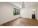 Spacious bedroom with hardwood floors, light fixture and large window at 555 Orme Ne Cir, Atlanta, GA 30306