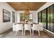 Dining room with wood-paneled ceiling, designer light fixture, and black-framed windows at 555 Orme Ne Cir, Atlanta, GA 30306