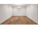 Dining room with modern chandelier, hardwood flooring, white walls and large windows at 555 Orme Ne Cir, Atlanta, GA 30306