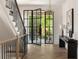 Elegant foyer with hardwood floors, a glass door, console table and staircase at 555 Orme Ne Cir, Atlanta, GA 30306