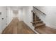 Bright hallway featuring hardwood floors and staircase with wooden handrail and iron balusters at 555 Orme Ne Cir, Atlanta, GA 30306