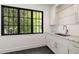 Bright laundry room with marble countertop, sink, and window view at 555 Orme Ne Cir, Atlanta, GA 30306