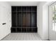 Mudroom features a built-in storage unit, patterned tile floor, and exterior door at 555 Orme Ne Cir, Atlanta, GA 30306
