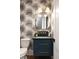Stylish powder room with designer wallpaper, modern lighting, and elegant fixtures at 555 Orme Ne Cir, Atlanta, GA 30306
