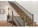 Stylish staircase with light wood steps and a decorative dark metal railing at 555 Orme Ne Cir, Atlanta, GA 30306