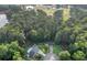Aerial view of a neighborhood highlighting mature trees, lush greenery, and a nearby lake at 600 River Bend Sw Cir, Smyrna, GA 30082