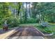 Landscaped backyard features a wooden deck, mulched area, brick border, and lush greenery at 600 River Bend Sw Cir, Smyrna, GA 30082