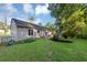 Expansive backyard showcases a stone path, well-maintained lawn, and the home's siding at 600 River Bend Sw Cir, Smyrna, GA 30082