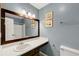 Bathroom featuring a vanity, dark wood framed mirror, toilet, and shower at 600 River Bend Sw Cir, Smyrna, GA 30082