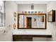Bathroom with long vanity counter, cabinet space, large mirror, and creative sunflower decorations at 600 River Bend Sw Cir, Smyrna, GA 30082