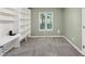 Carpeted bedroom with built-in bookshelves and bright window at 600 River Bend Sw Cir, Smyrna, GA 30082