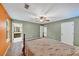 Bedroom featuring carpeted flooring, ceiling fan, and connected bathroom access at 600 River Bend Sw Cir, Smyrna, GA 30082