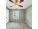 Carpeted bedroom with a window showing the natural outdoor environment and a ceiling fan at 600 River Bend Sw Cir, Smyrna, GA 30082