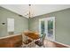 Charming dining area with a view of the backyard through glass paneled doors, wood table and floors at 600 River Bend Sw Cir, Smyrna, GA 30082